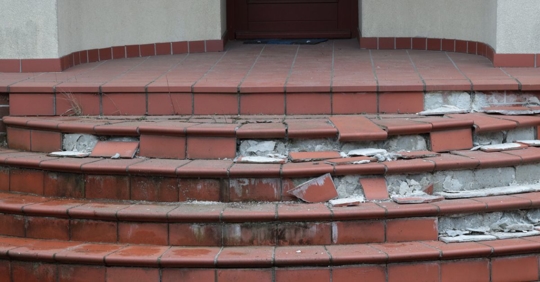 Broken steps in front of a house