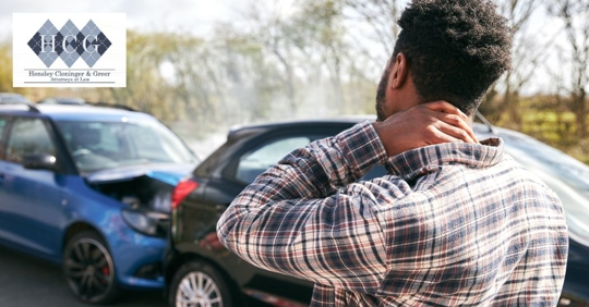 man holding his neck injured after a car crash